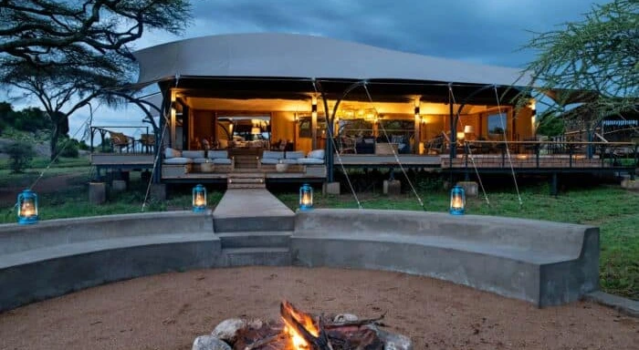 Luxury safari lodge exterior at dusk